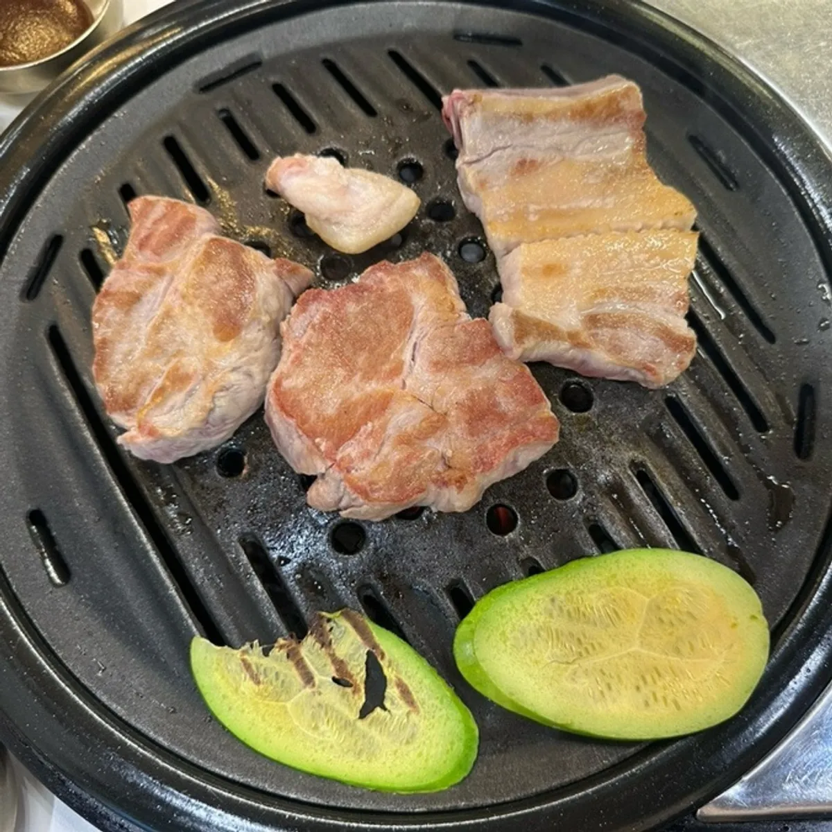 Thick pork cuts placed on the grill