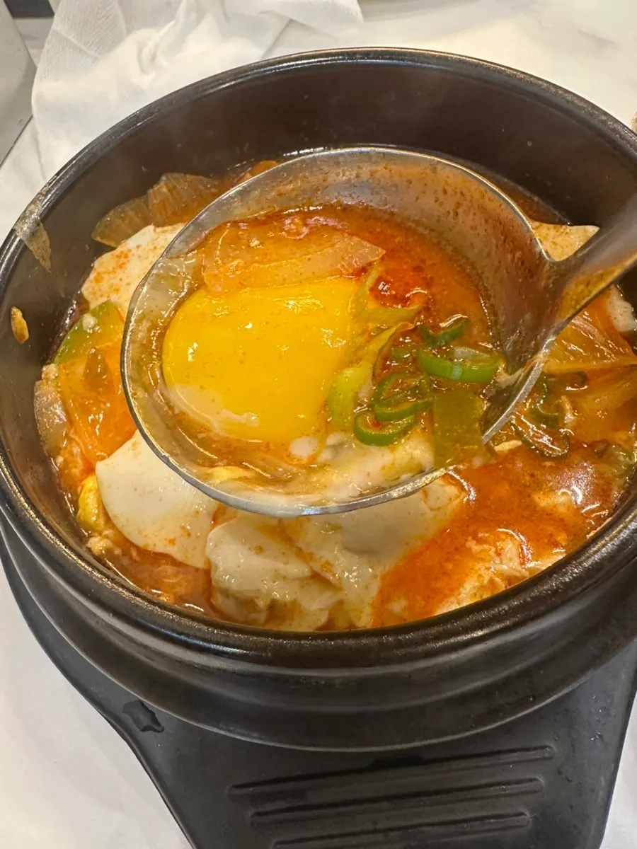 Pot of soft tofu stew bubbling on the burner