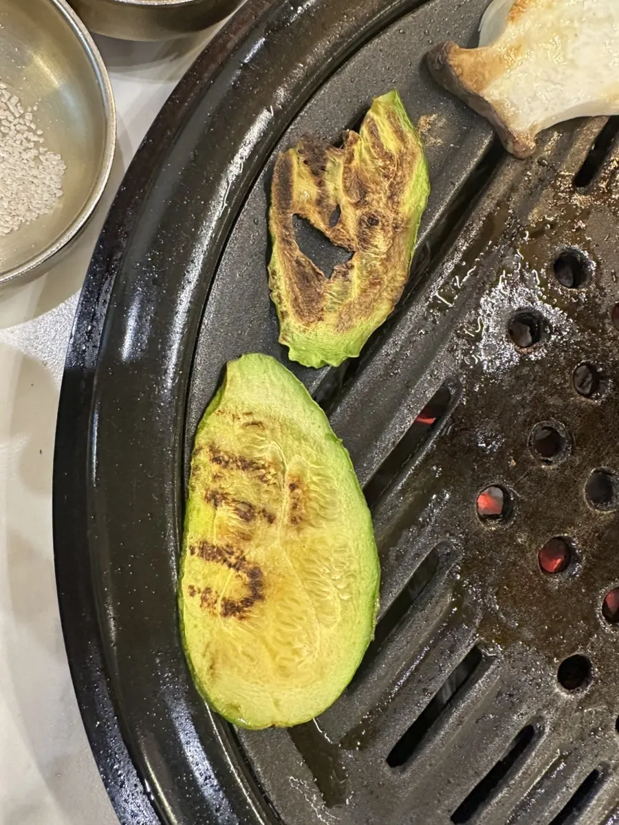 Grilled meat and vegetables together on the grill plate