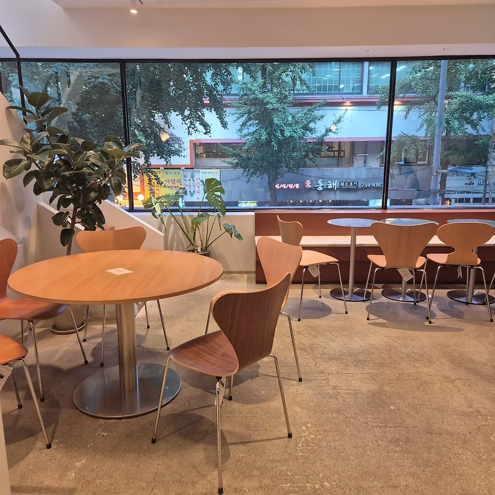 Café seating by floor-to-ceiling windows