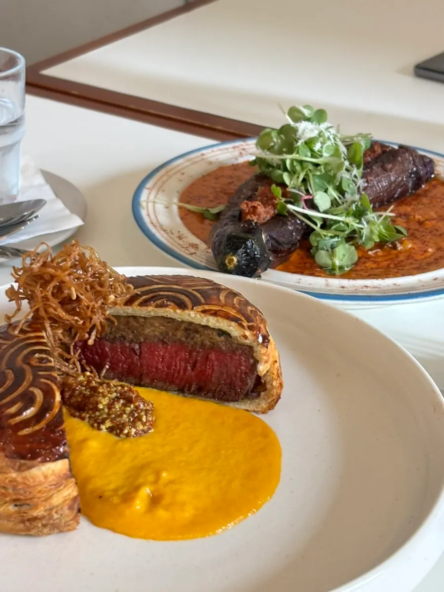 Table spread of Beef Wellington and rosé eggplant shrimp