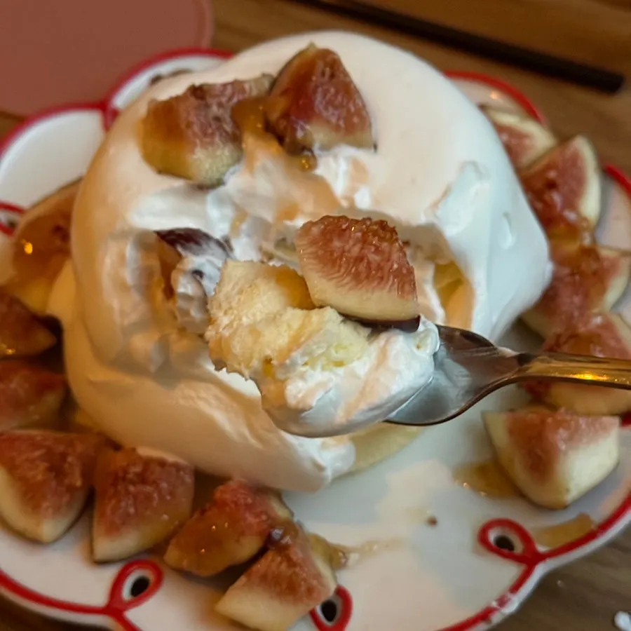 A fluffy bite of soufflé lifted on a fork