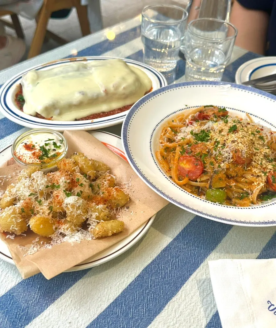 Table set with ordered lasagna and pasta