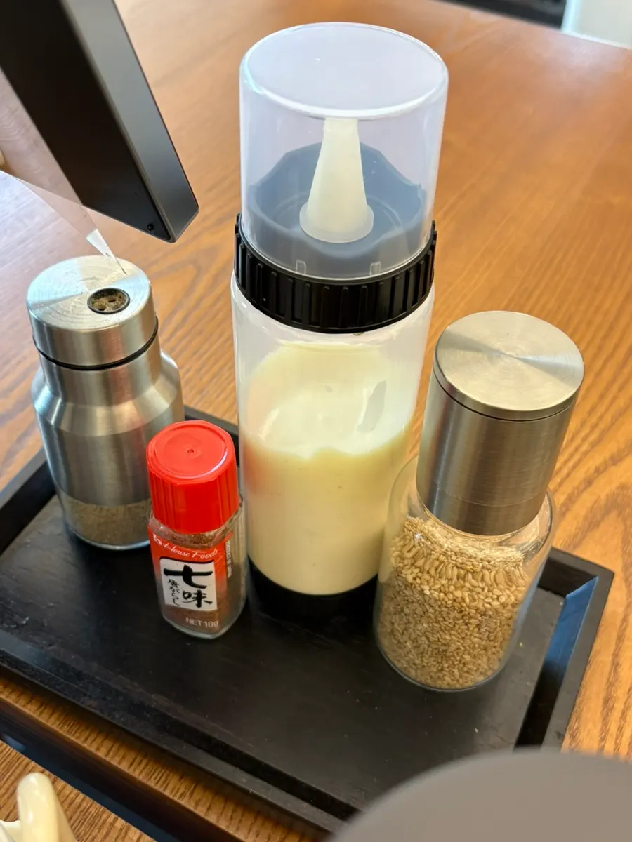 Table setting with salad dressing and shichimi