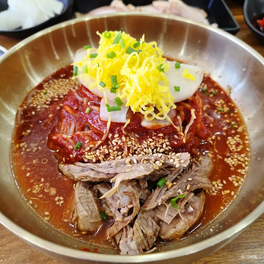 Seoul Myeonok's bibim naengmyeon topped with sauce