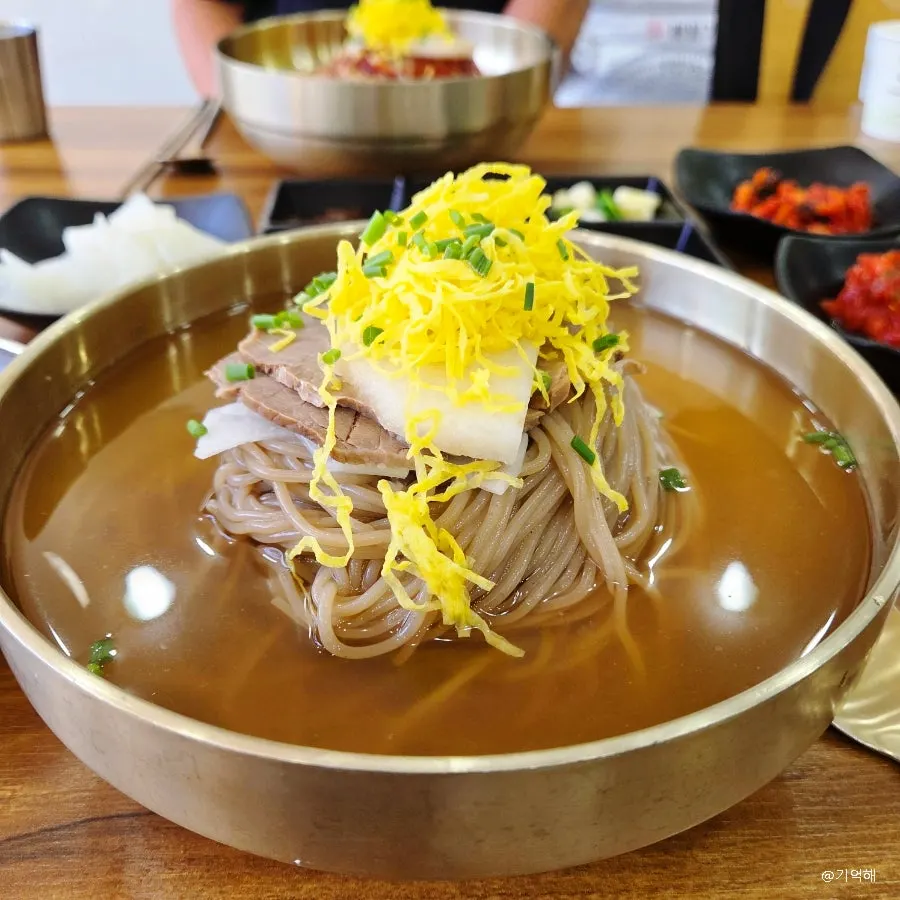 The full spread of pyongyang naengmyeon, bibim naengmyeon, and boiled pork