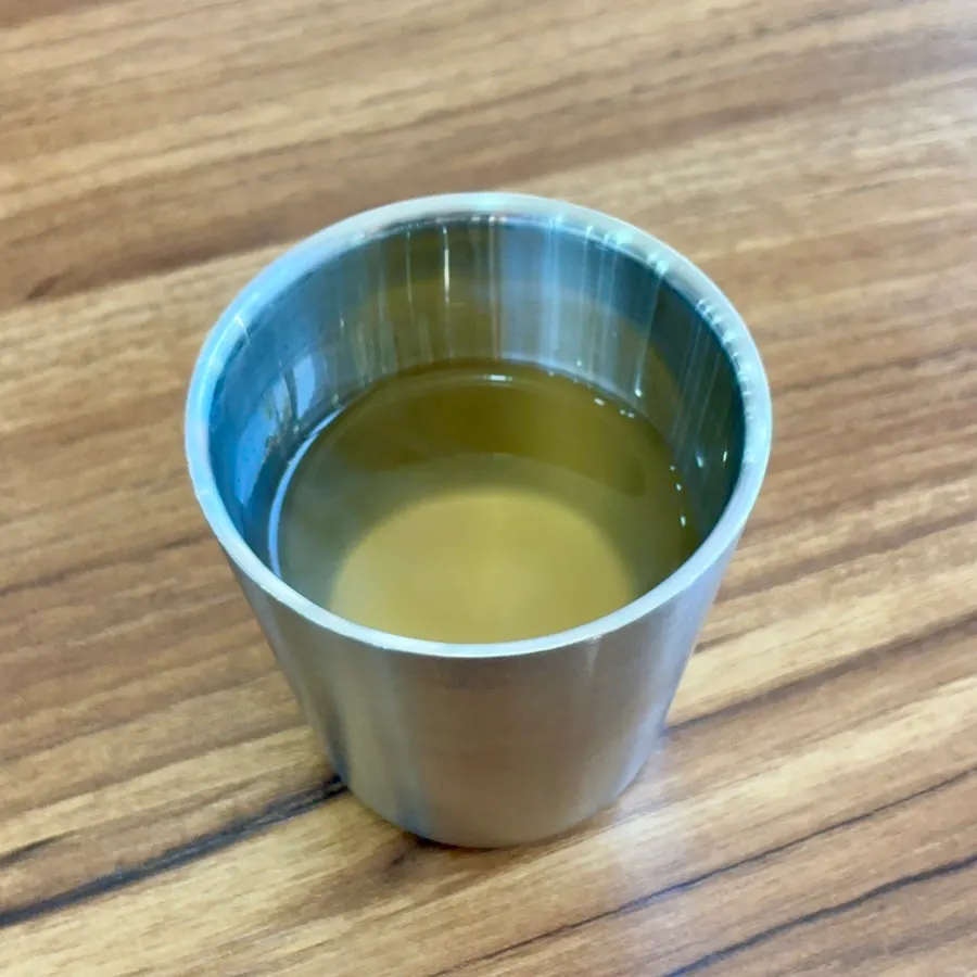 A cup of self-serve warm broth at Seoul Myeonok