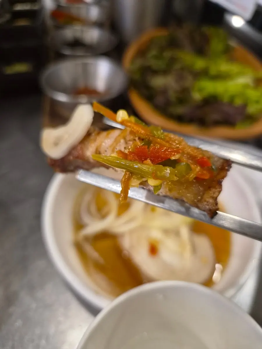Grilled meat dipped in accompanying sauce