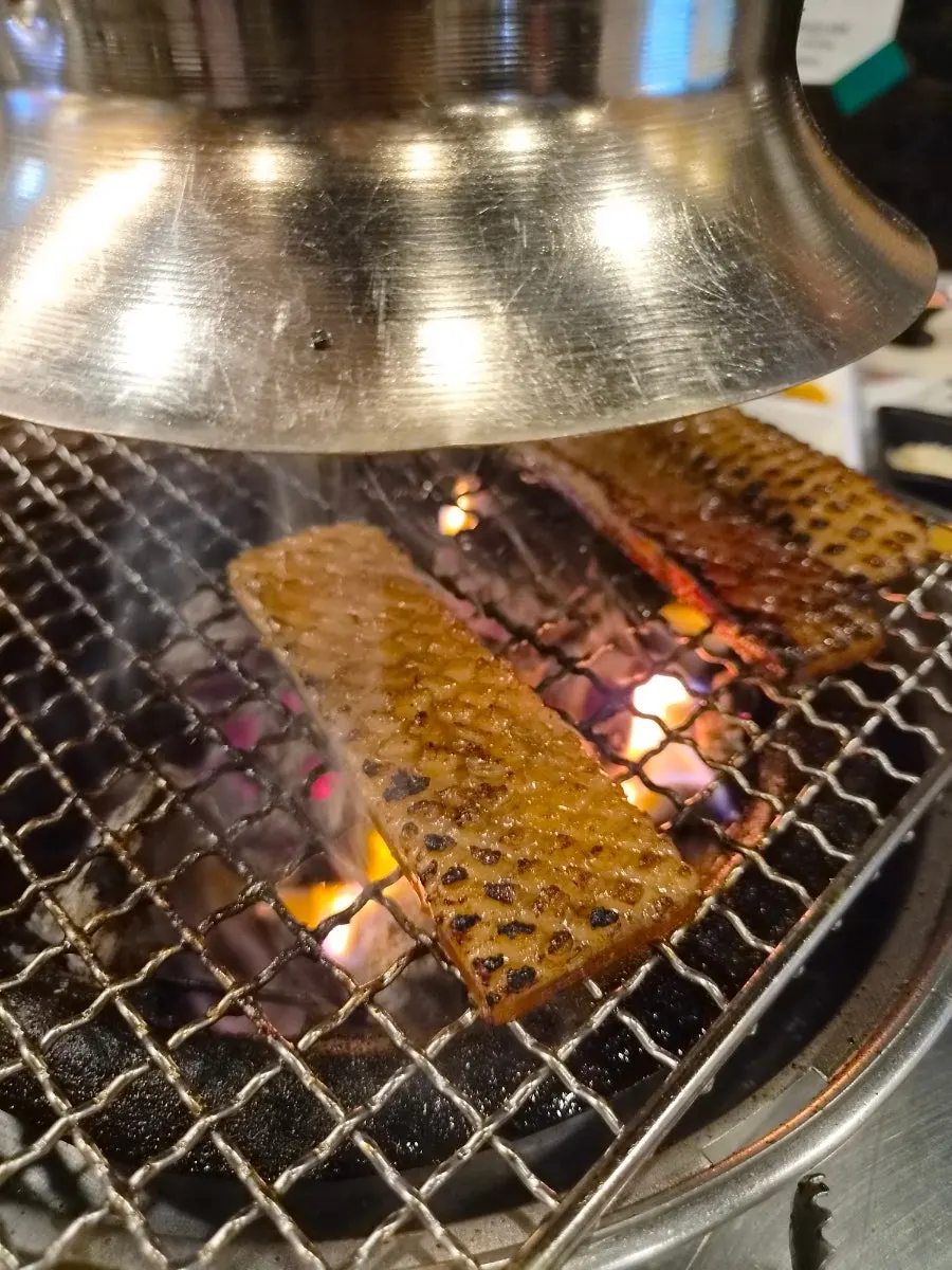 Pork skin grilling over charcoal