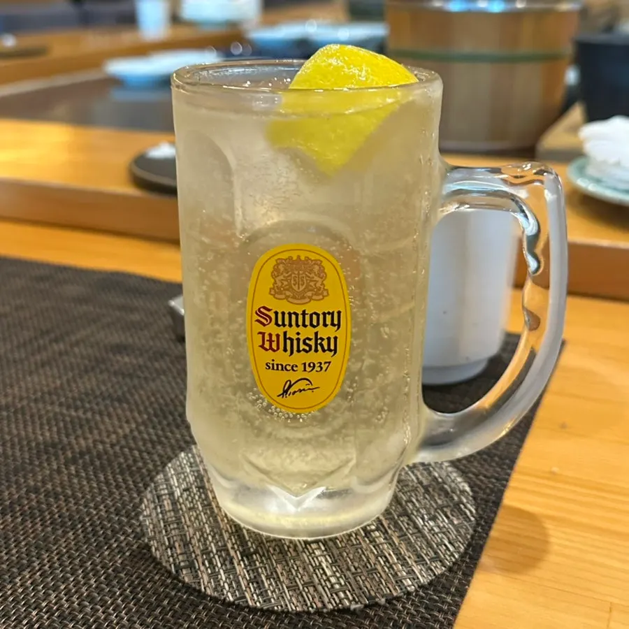 A Suntory highball served alongside the course