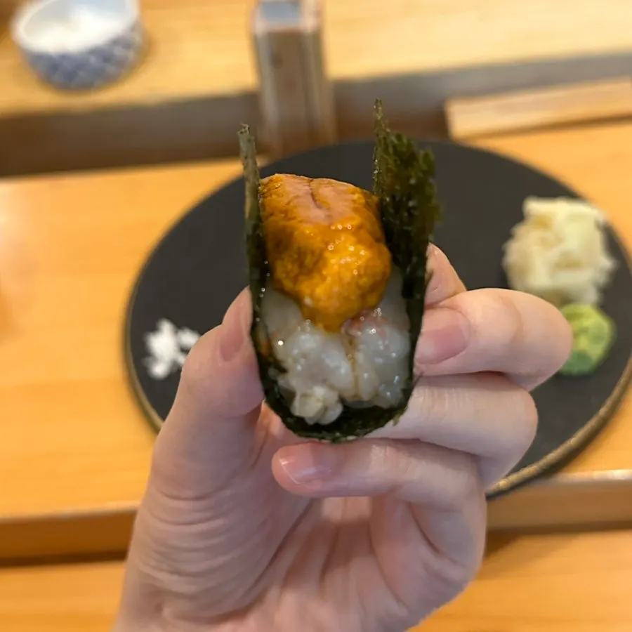 Close-up of sweet shrimp sushi topped with uni