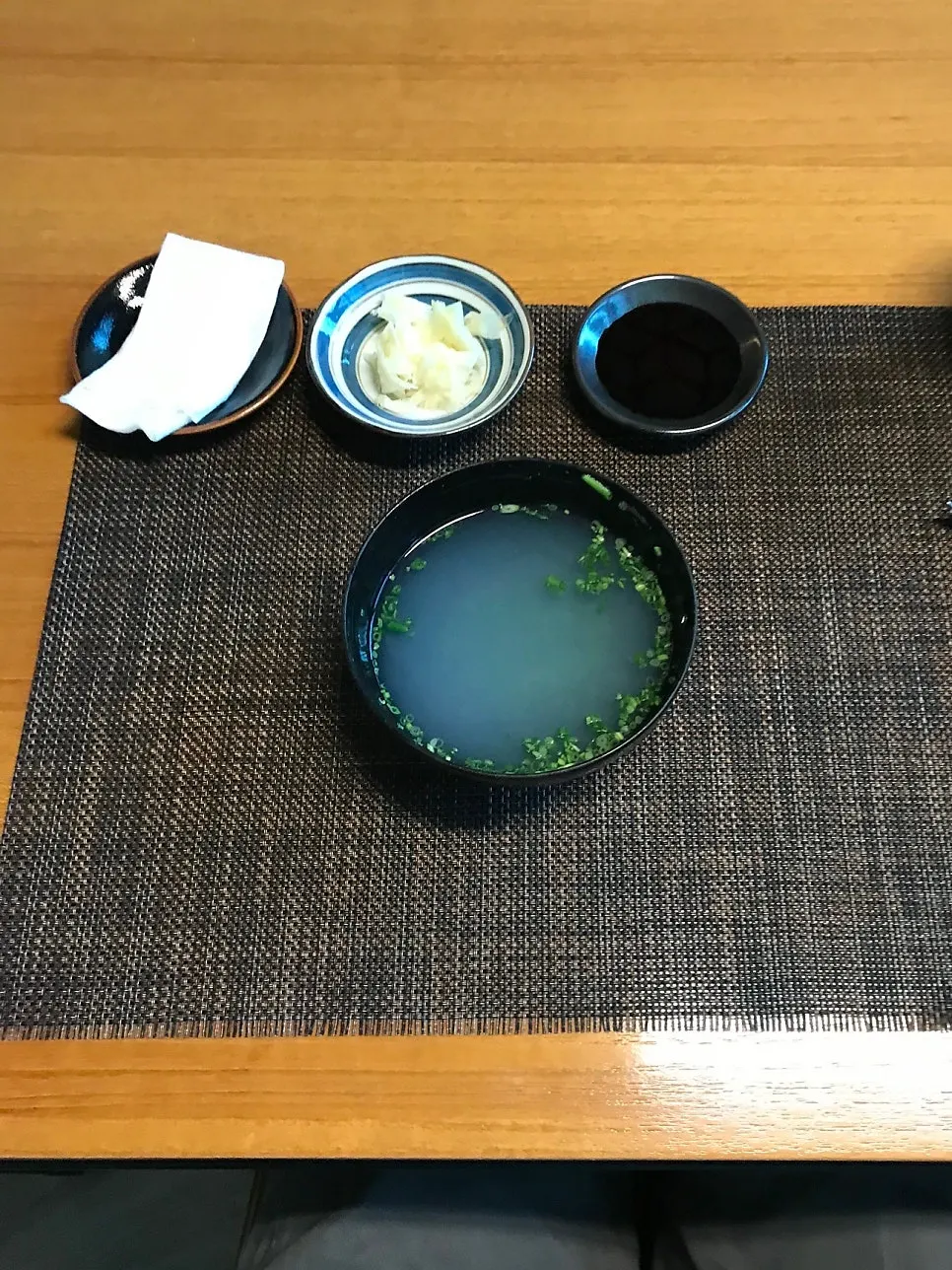 Clear clam soup served to drink straight from the bowl