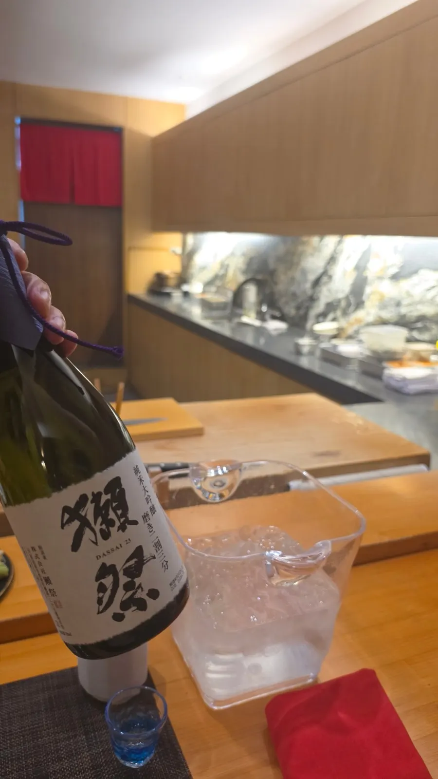 Dassai 23 sake chilling in an ice bucket