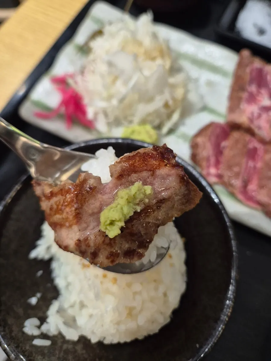 A piece of gyukatsu topped with wasabi