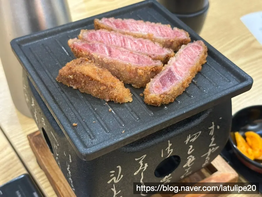 A piece of gyukatsu served medium-rare