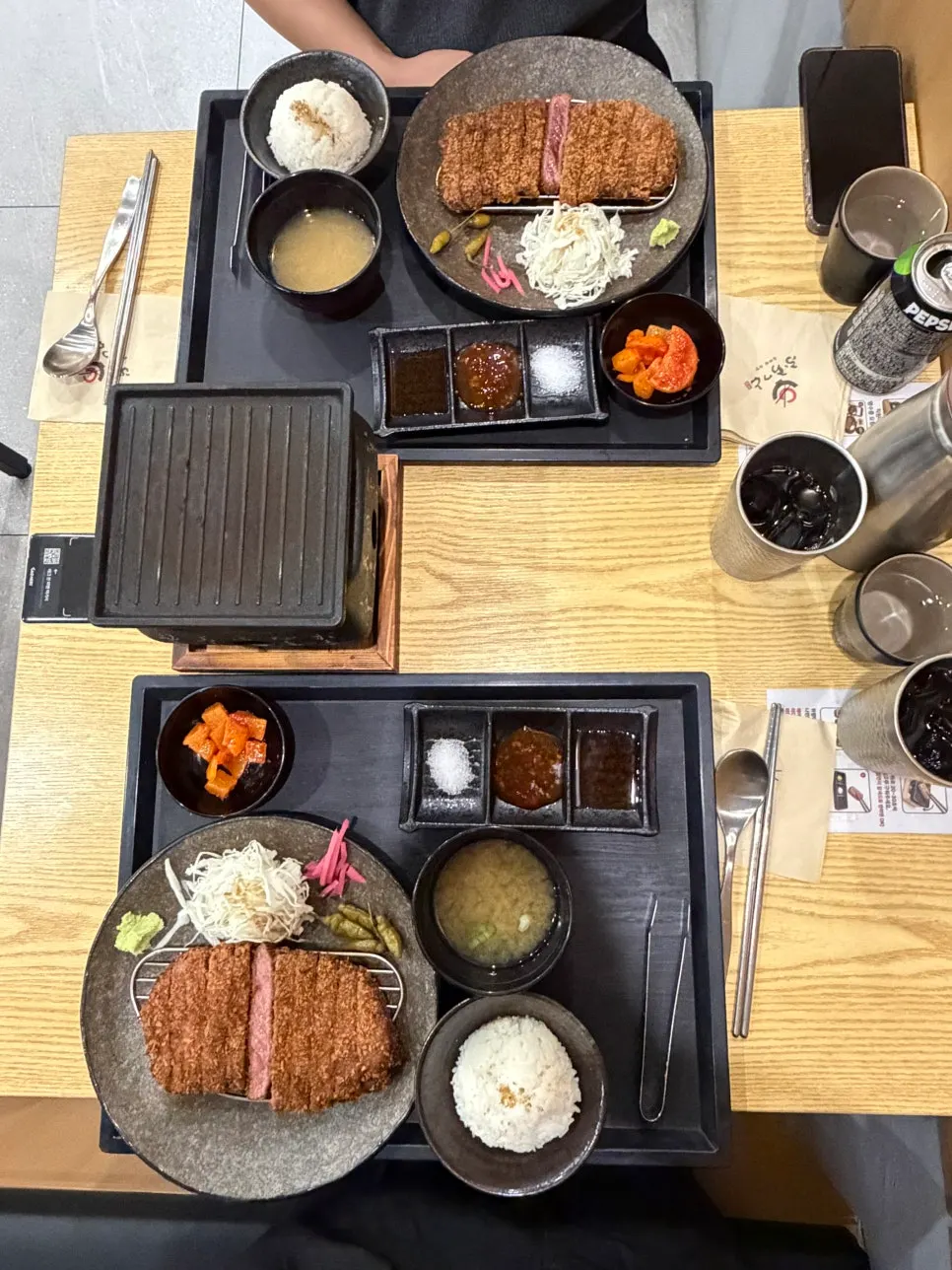 Two gyukatsu sets served with rice and miso soup
