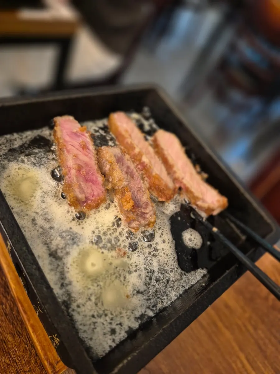 A spoonful of rice with gyukatsu