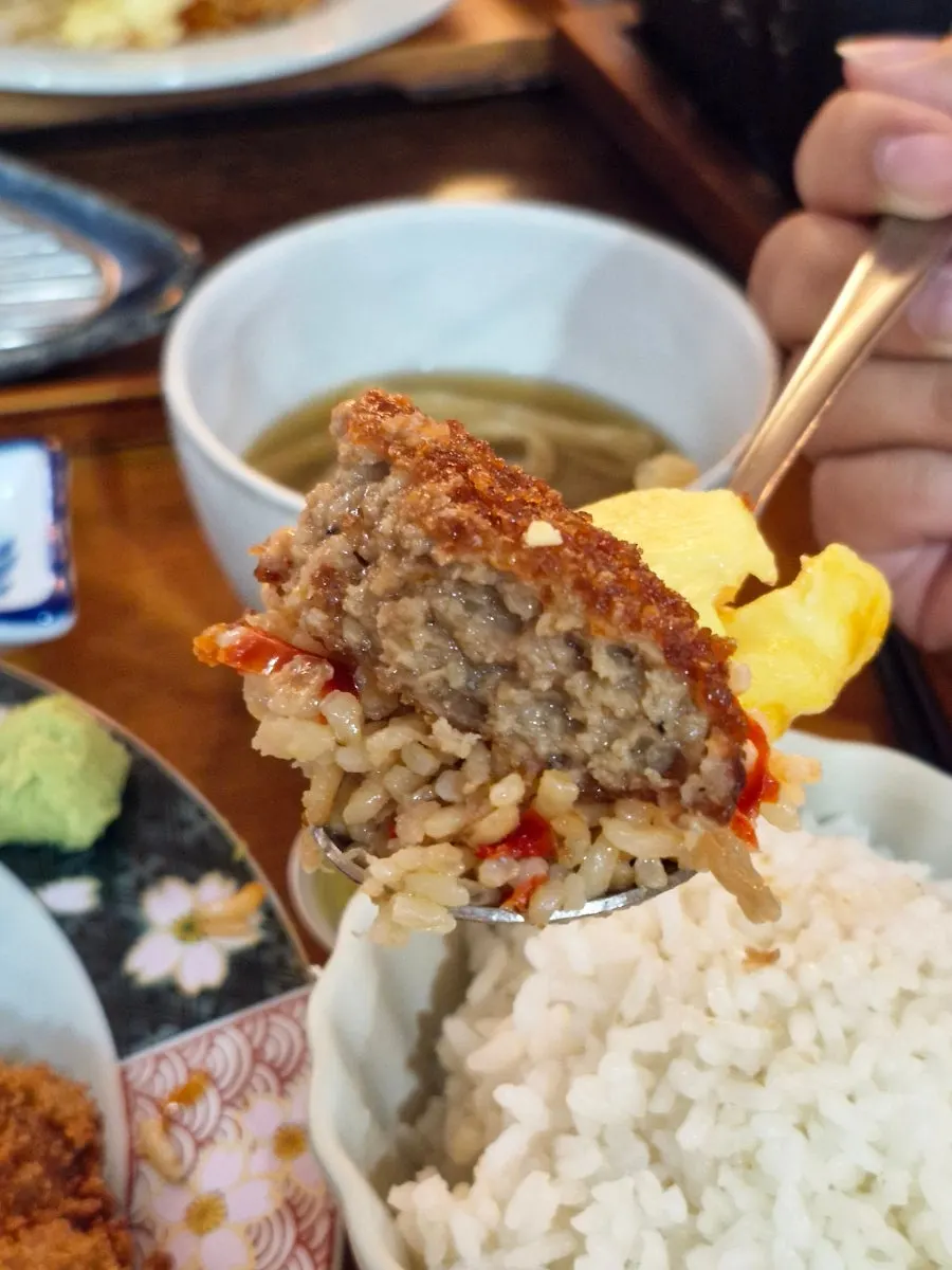 A spoonful of fried rice scooped from inside the omurice
