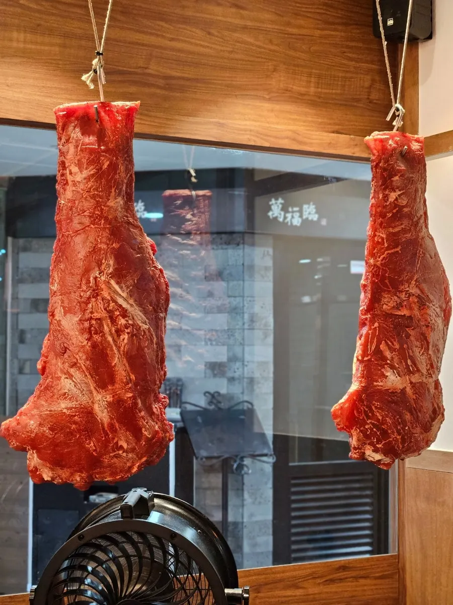 Large model of a meat chunk displayed outside the restaurant