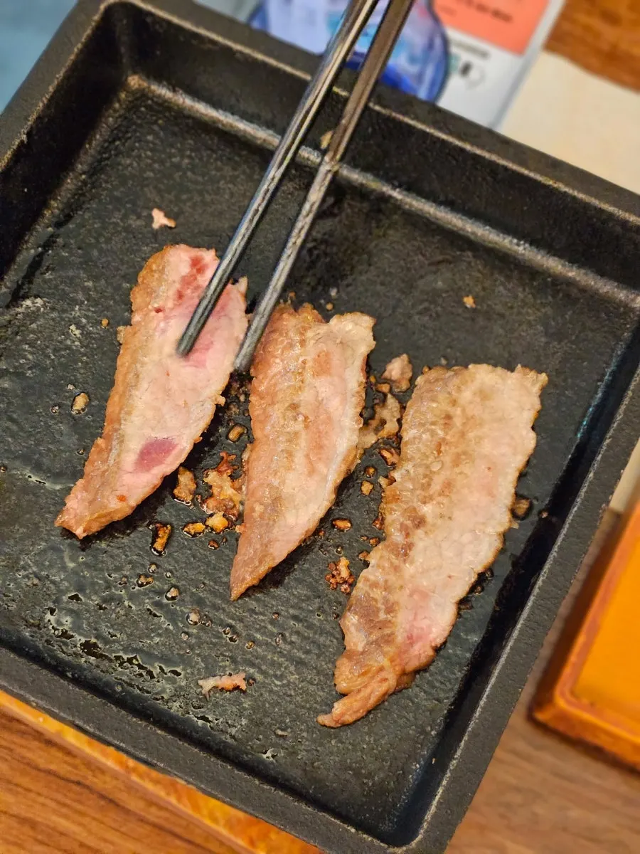 Sirloin steki grilling on the brazier