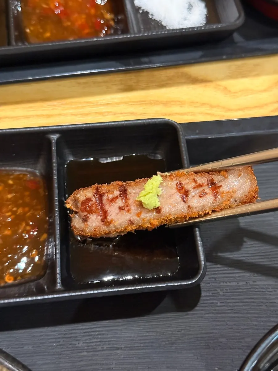Gyukatsu dipped in soy-based sauce