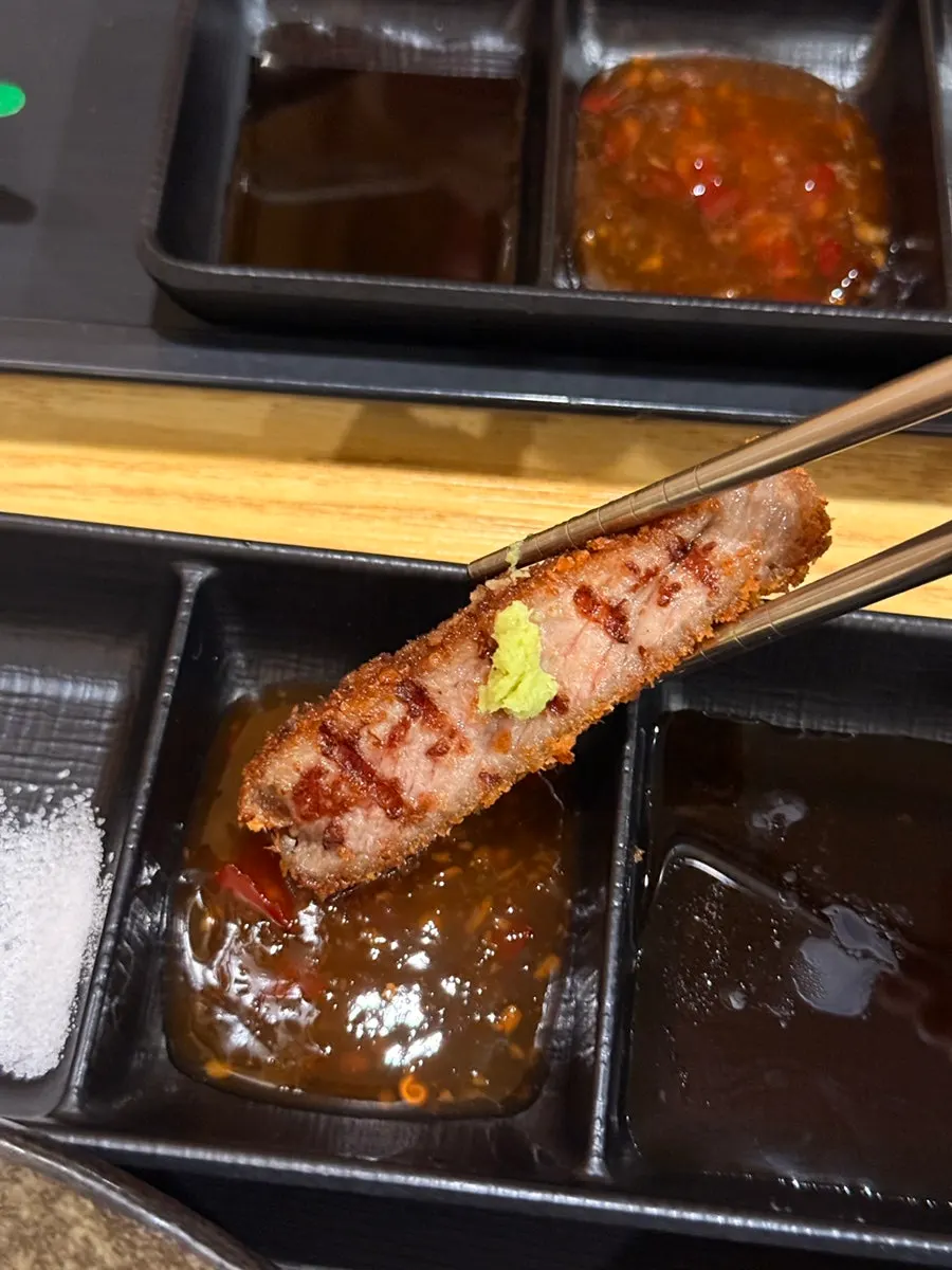 Gyukatsu dipped in spicy chili sauce