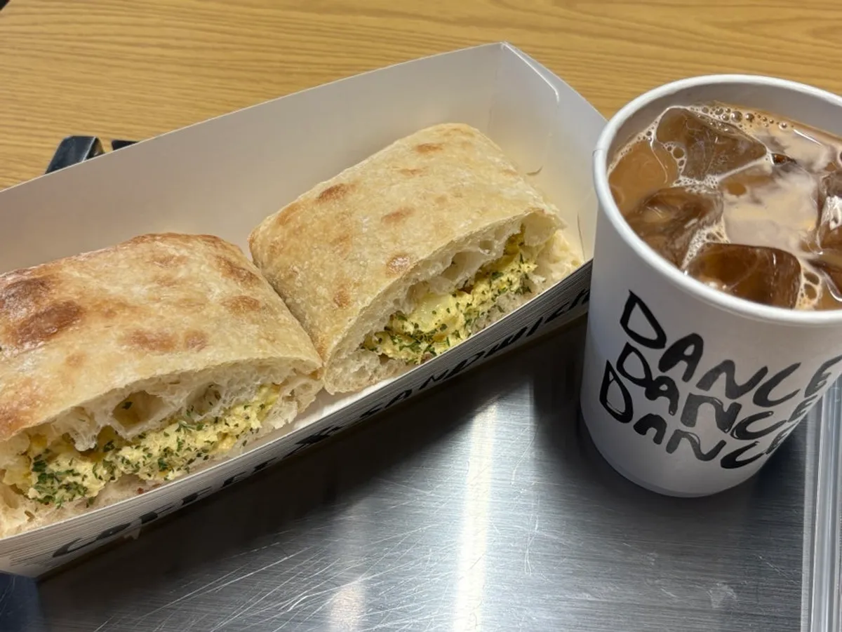 Ham and egg sandwich served with oat milk latte