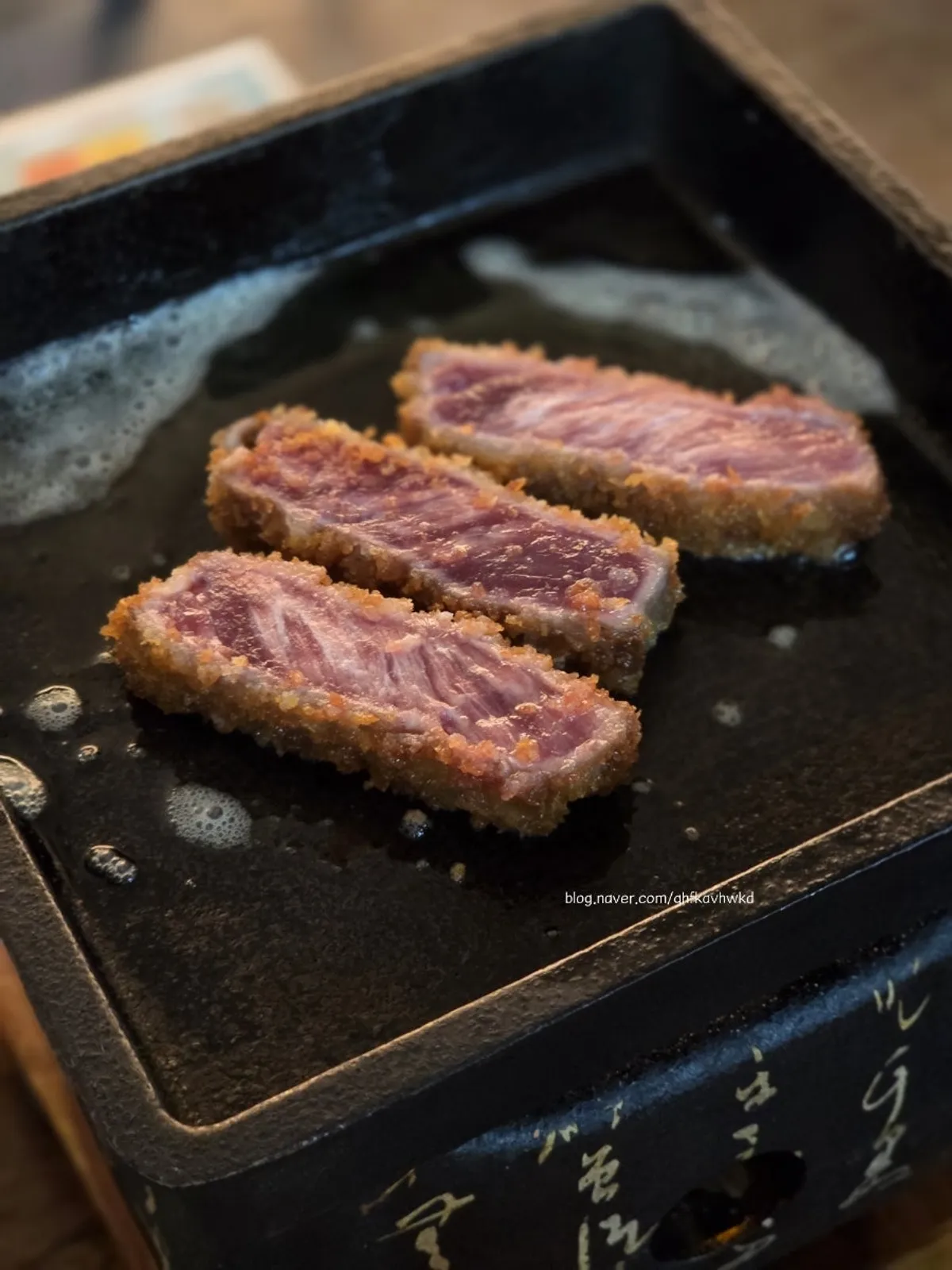 Grilling gyukatsu on the brazier