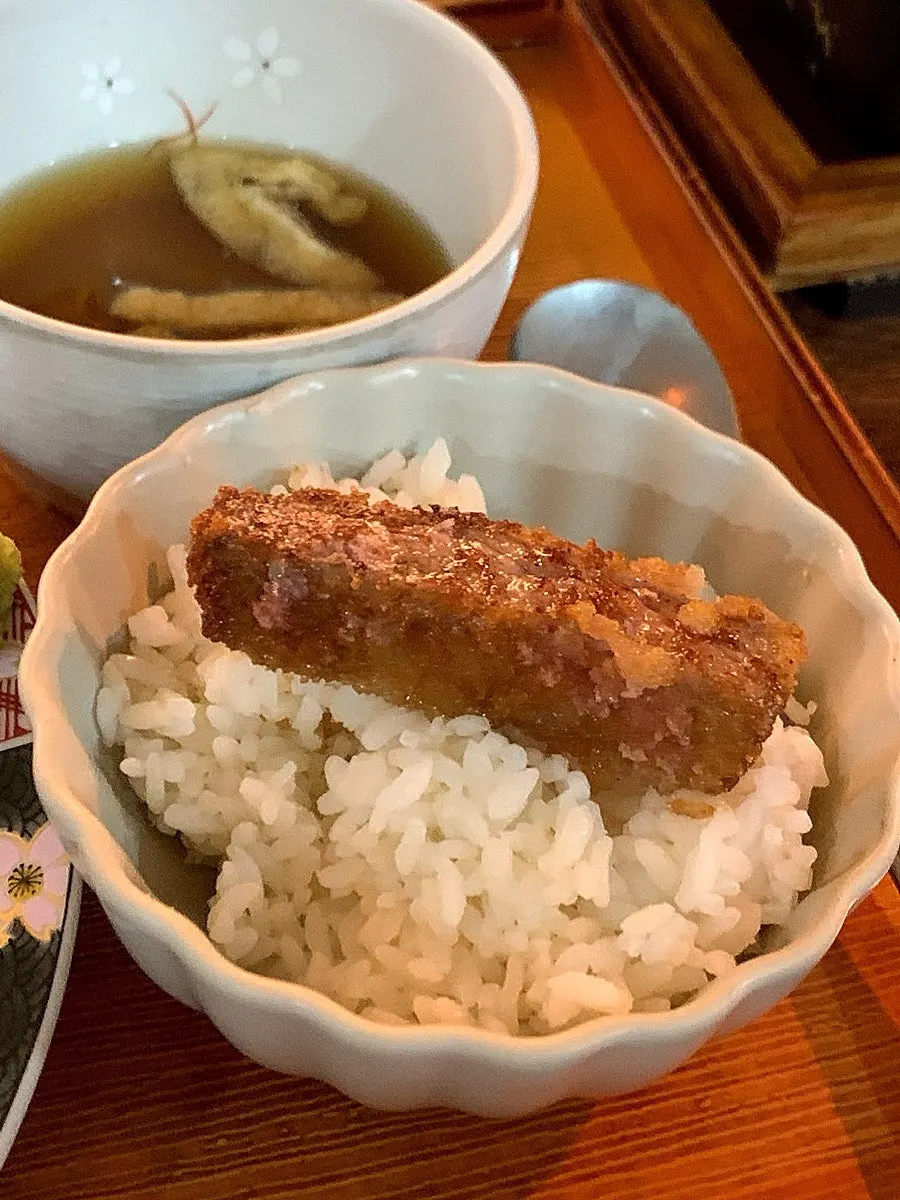 Sirloin gyukatsu being grilled piece by piece over the brazier