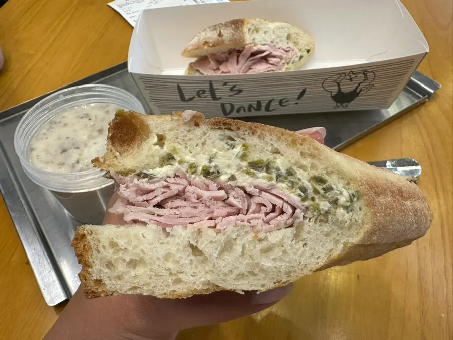 Close-up of jambon and cream cheese inside the crisp baguette