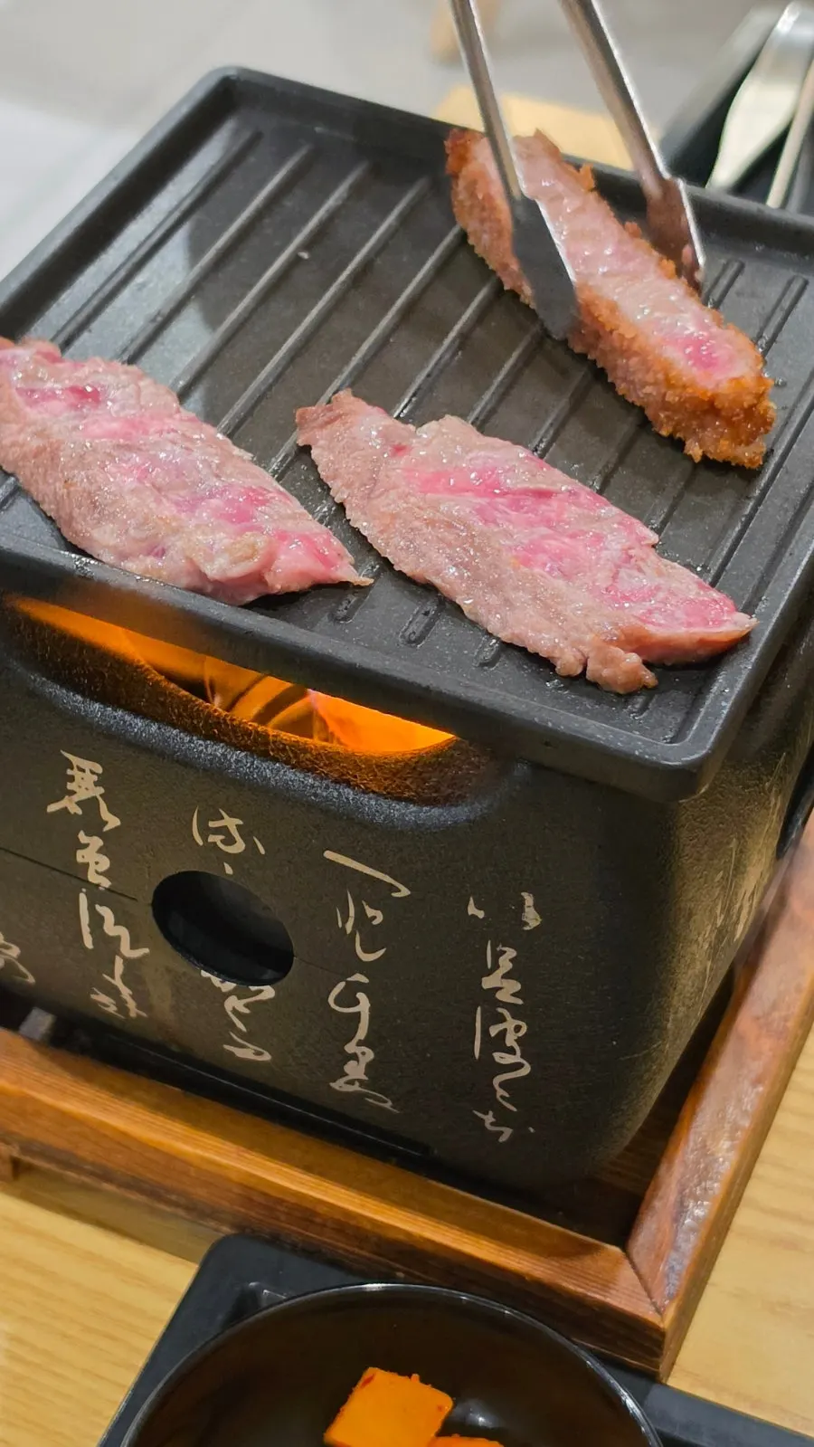 Mini charcoal grill prepared with solid fuel