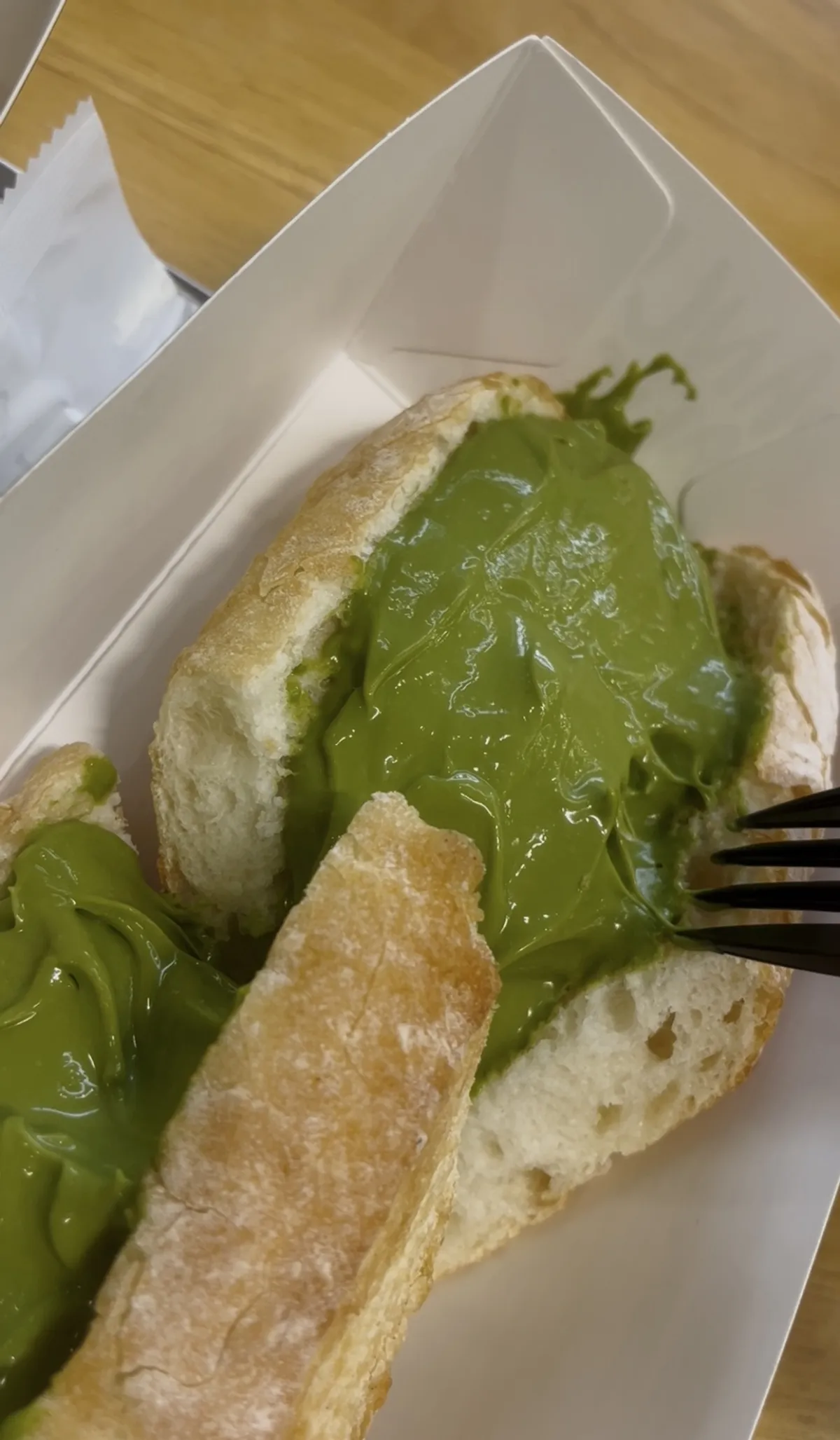 Cross-section of the matcha tofu cream cheese baguette pulled open