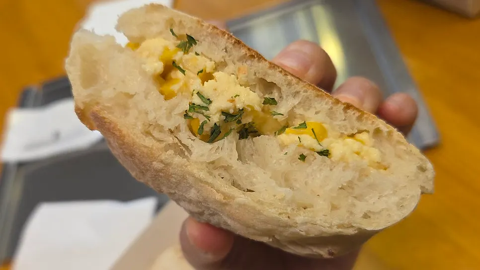 Cross-section of the tofu cream cheese ciabatta with corn kernels