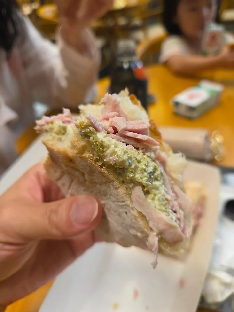 A bite taken out of the jambon jalapeño ciabatta sandwich