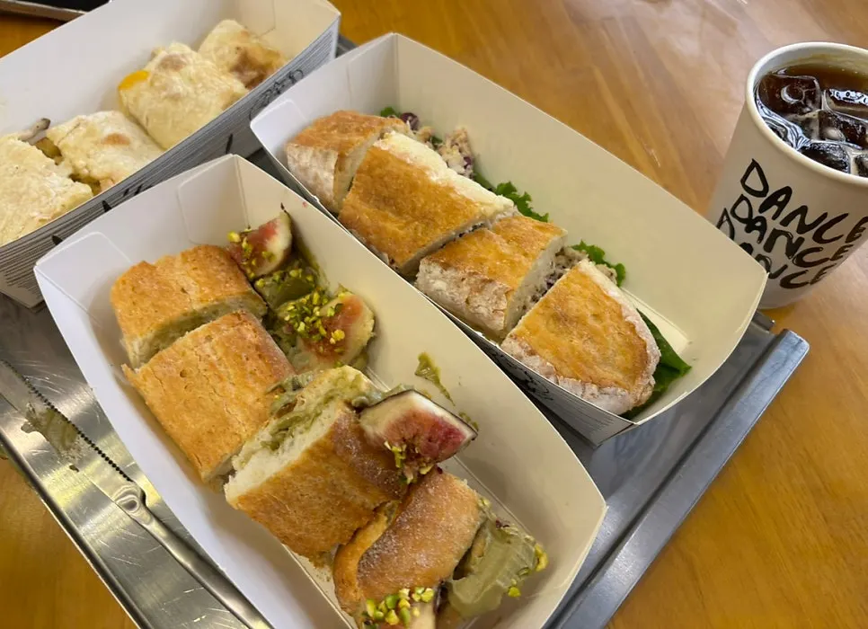 Three sandwiches and a knife on the table