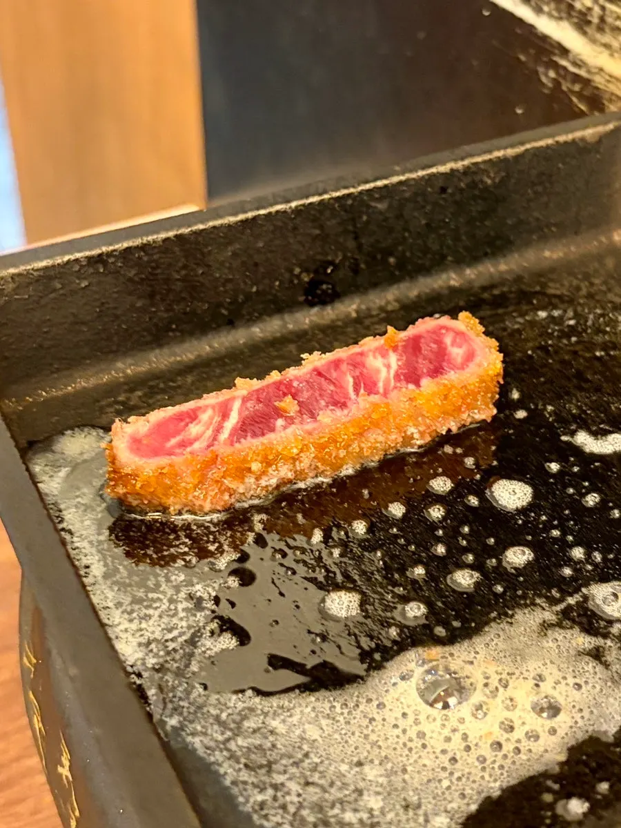 Gyukatsu cooking on melted butter