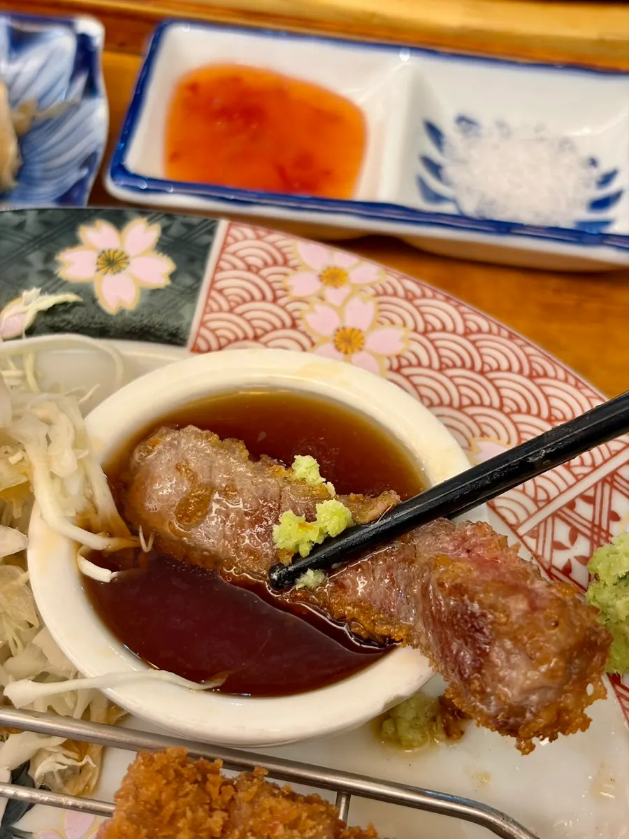A piece of gyukatsu topped with wasabi