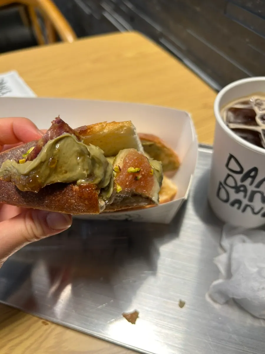 A bite taken out of the fig pistachio baguette