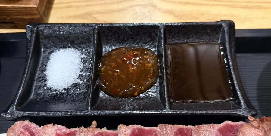 Salt, steak sauce, chili sauce, and accompaniments