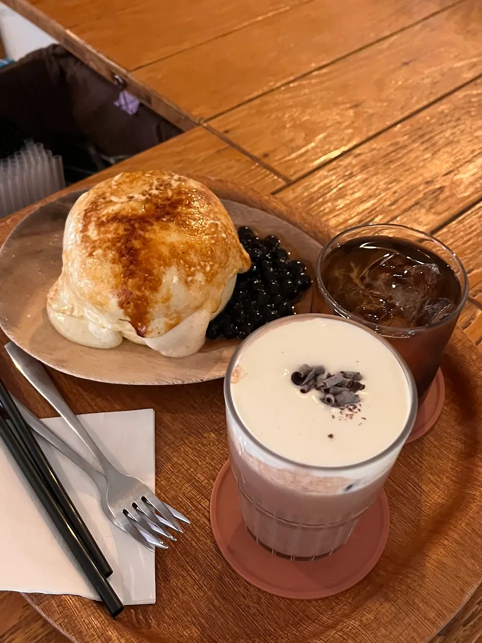 Table set with the pearl crème brûlée soufflé and two drinks