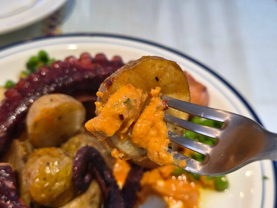 Octopus dish with potatoes and peas