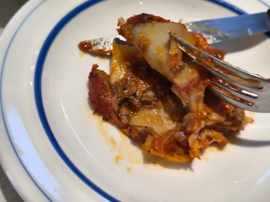 A slice of lasagna with aligot cheese