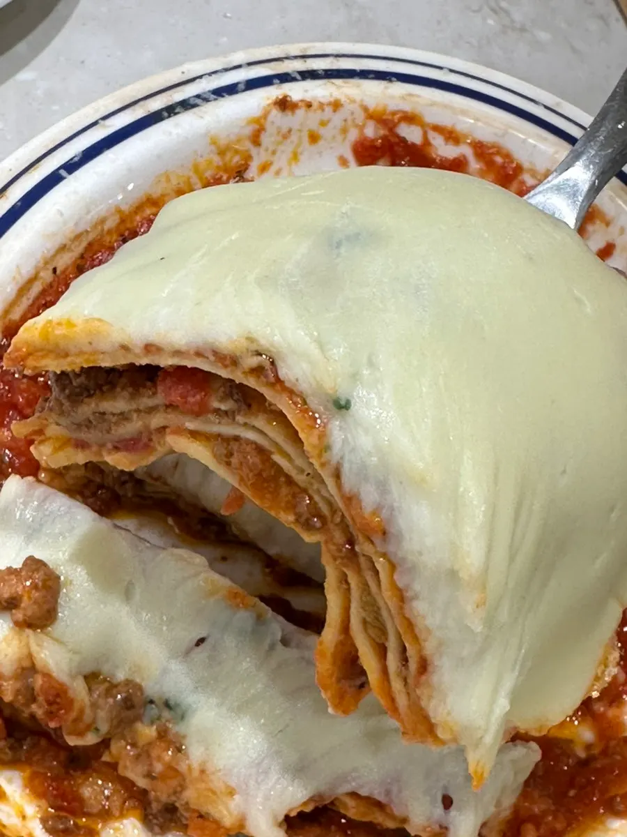 Lasagna topped with stretchy cheese