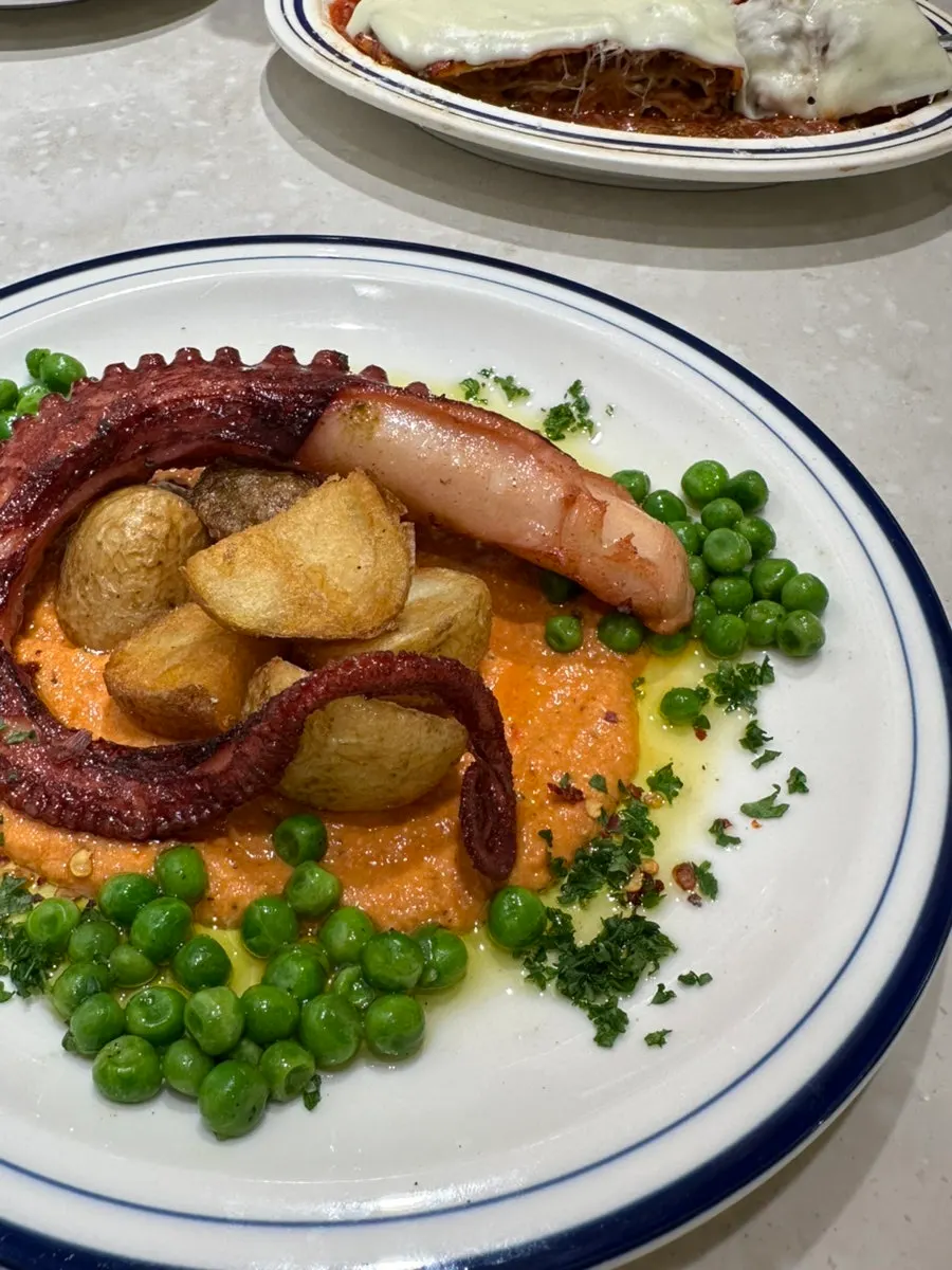 Octopus dish with potatoes and peas
