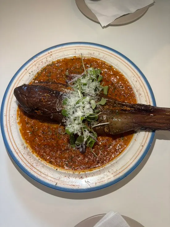 Whole eggplant presentation of the rosé eggplant shrimp