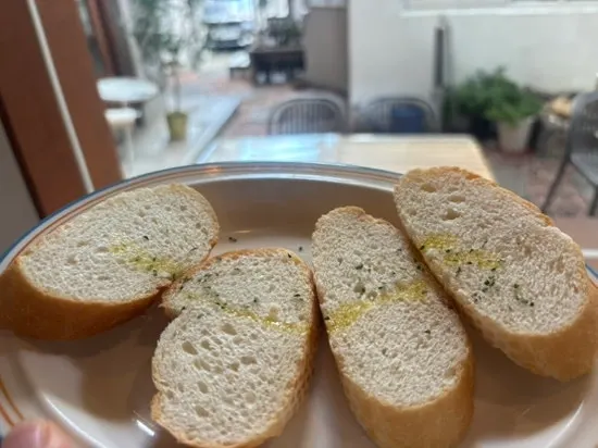 Pre-meal baguette drizzled with olive oil and parsley