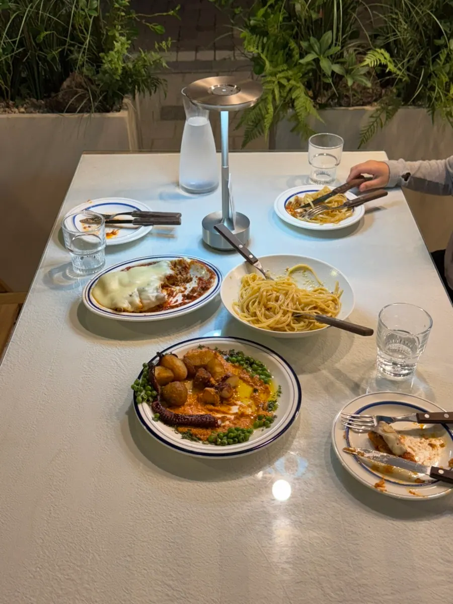 Table with both lasagna and polpo ordered together
