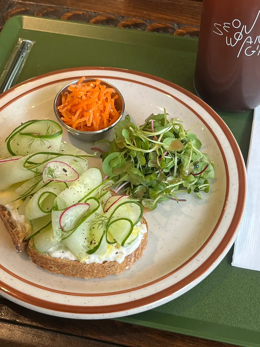 Cross-section of the sandwich with cucumber slices and side salad