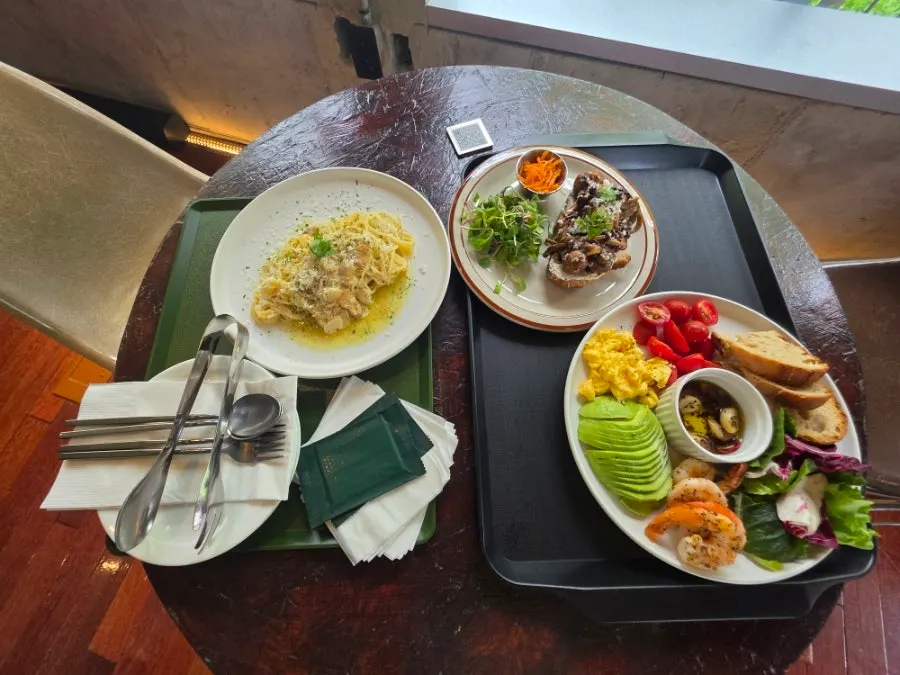 Three brunch dishes set on a 2nd floor window table