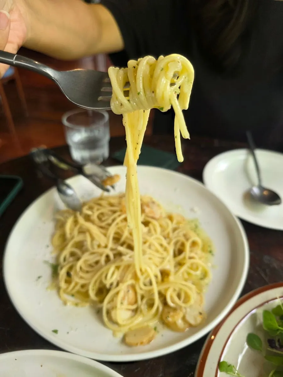 Chunky garlic pieces visible between the pasta noodles